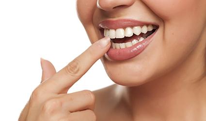 A woman pointing at her teeth